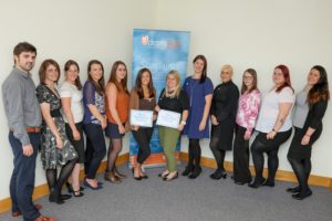 is a photograph of staff at Dezrezlegal who have completed dementia training.